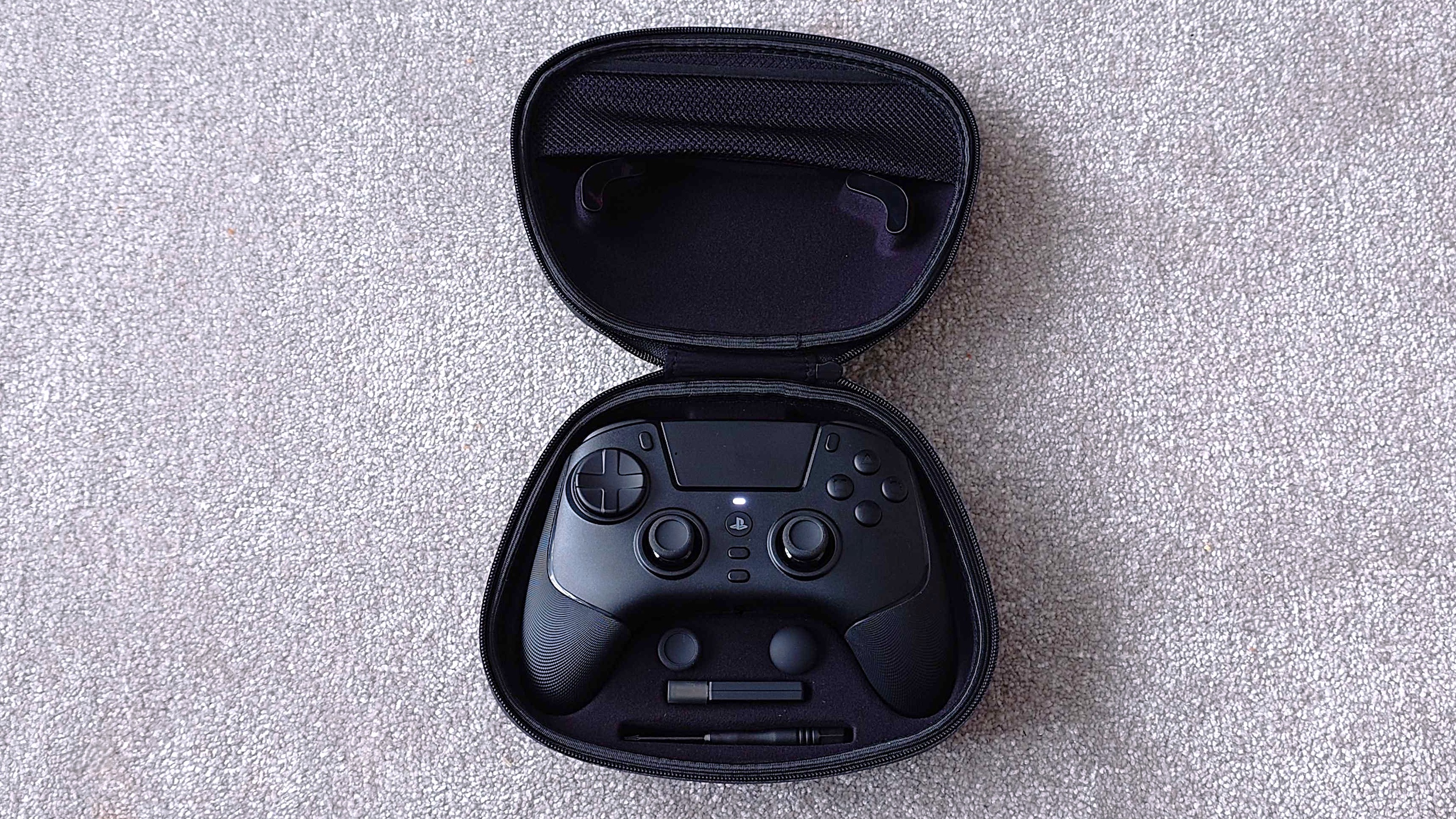 Razer Raiju V3 Pro controller in its carry case with additional accessories.