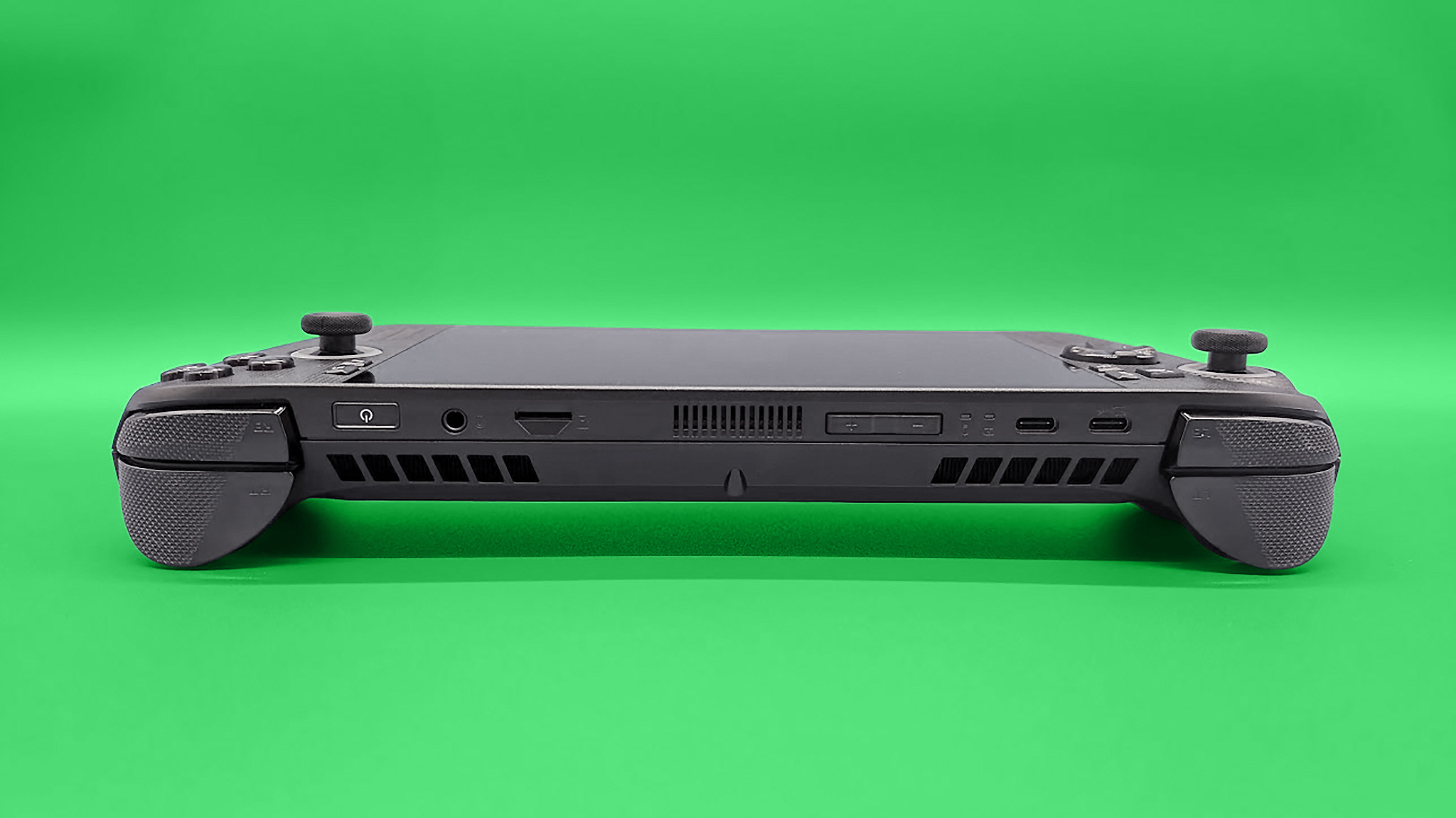 The ROG Xbox Ally X laying down with the vents, buttons, and ports on top of the handheld visible.