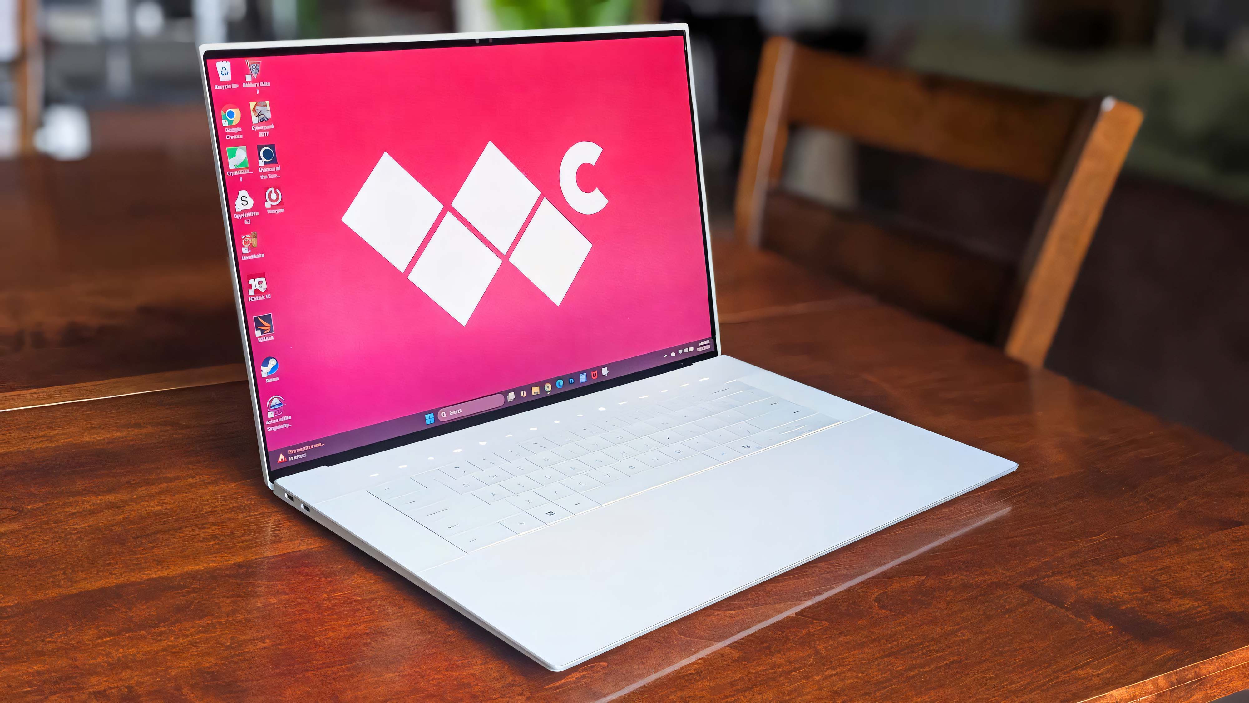 Dell 16 Premium laptop sitting on a wooden table. The Windows Central logo is displayed as the background.