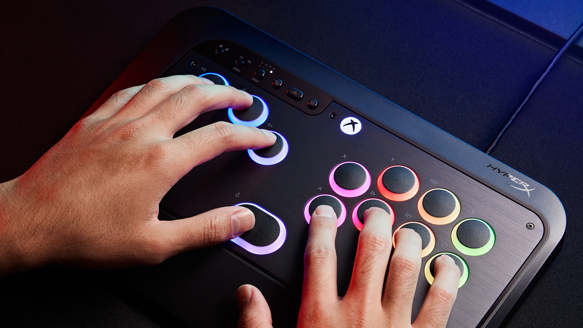 HyperX Clutch Tachi promotional image showing the fighting controller with RGB buttons on a dark desk